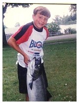 bill's grandson trying to pick up a 35 pound salmon.jpg